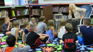 Tina March and Students reading together in the Bowman Woods Library